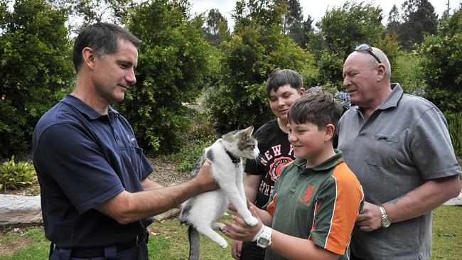 Pictured are Allan Bailey and sons Jonty(13) and Jordie(11) being reunited with their cat Tubby with the help of Steven Austin (Companion Animal Advisory Officer) at the Campbelltown Animal Care Facility