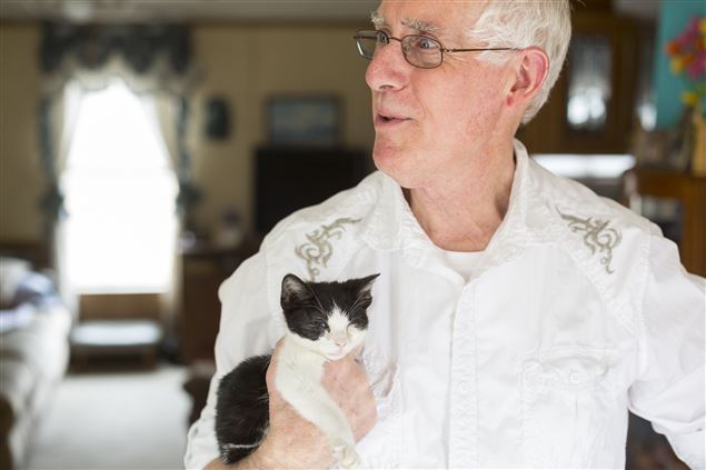 Dan Shaw holds Mimi, a 2-pound, 4-ounce domestic shorthair rescue kitten, Thursday, March 26, 2015, in Elkhart. Mimi had been discovered in an Edwardsburg mailbox before finding her way to the Shaws' home three weeks ago. "That's what everybody finds ironic, is she was found in a mailbox and then rescued by another person," Dan Shaw said, "then rescued and taken in by a mail carrier." (Nick Gonzales/The Elkhart Truth)
